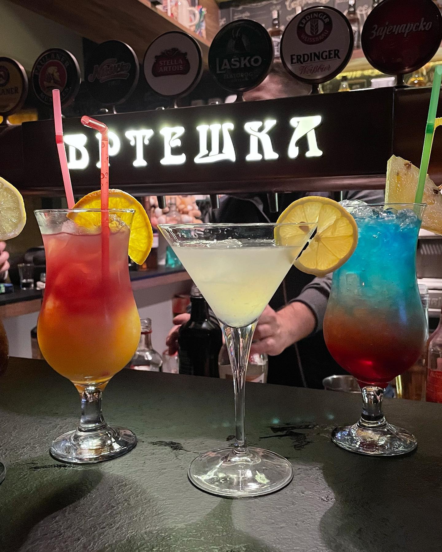 A selection of colorful, expertly crafted cocktails on the bar at Vrteska.