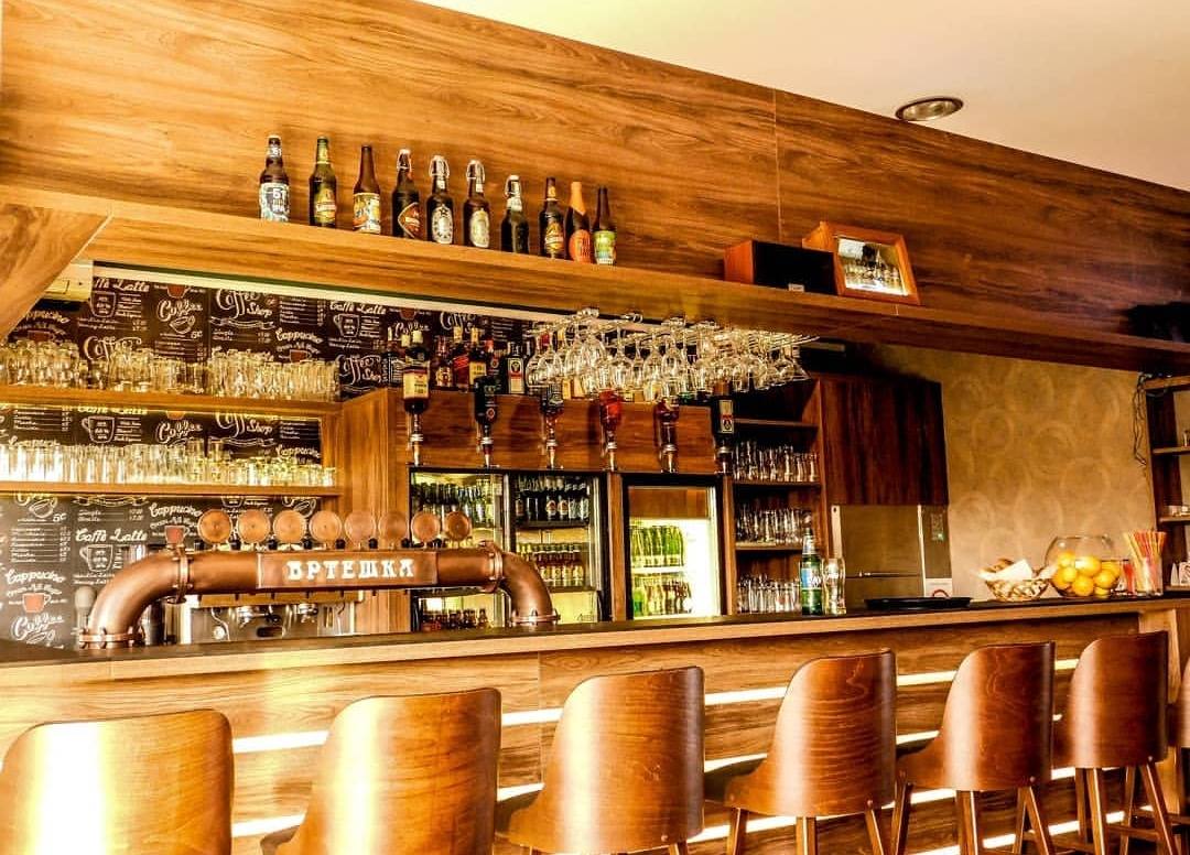 The warm, rustic wooden bar inside Vrteska Restoran.